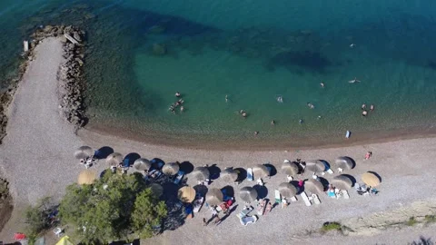 Aerial top down view of a resort beach with umbrellas and sunbeds. Stock Footage 343940215