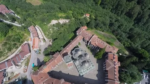 Aerial top down view of rila monastery in bulgaria surrounded by dense green Vídeos de archivo 348366341