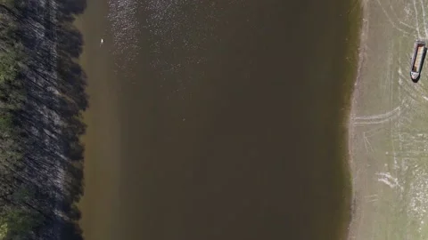 Aerial Top-Down View of River with Boat, Drone Footage Видео 153175434