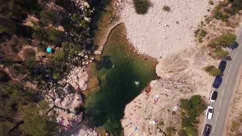 Aerial top down view of a river with rocks and people Stock Footage 153346542