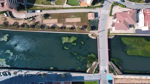 Aerial top down view of river filled with algae bloom and bridge Costa Brav.. Stock-Footage 245993087