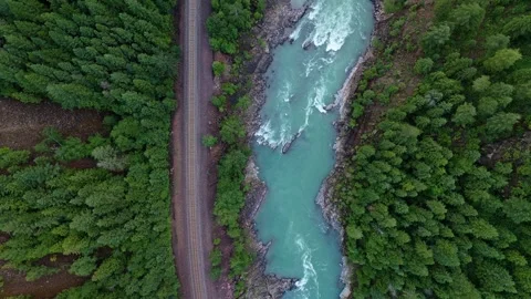 Aerial Top Down View of a River and Railroad Tracks Near Glacier National Park Stock Footage 339369430