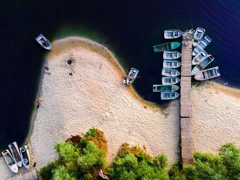 Aerial top down view of river pier with boats in summer at sunset Stock Photos