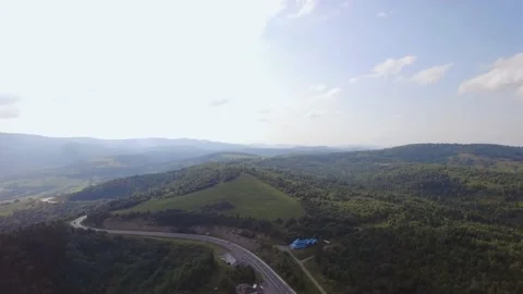 Aerial top down view of road in forest in the summer, misty morning, rest area Stock Footage 221018768