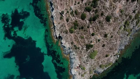 Aerial top down view of rock structures in the Mediterranean Sea in Port Ll.. Stock-Footage 245931490