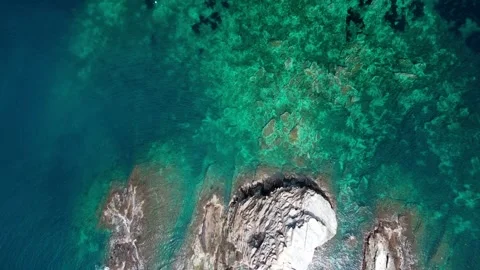 Aerial top down view of rocks in the Mediterranean Sea along Costa Brava Ca.. Video stock 245917466
