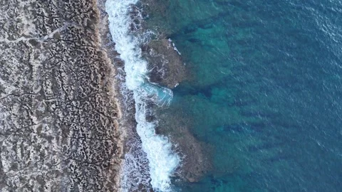 Aerial top-down view of rocky coastline and deep blue sea on a cloudy day, Greec 스톡 동영상 303304890