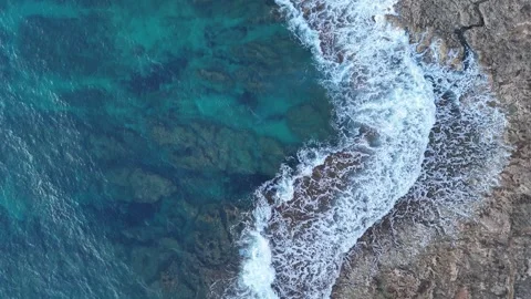 Aerial top-down view of rocky coastline and deep blue sea on a cloudy day, Greec 스톡 동영상 303304982