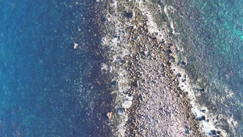 Aerial Top Down View of Rocky Reef and Clear Blue Sea at Manazuru Cape 4K Video stock 329058661