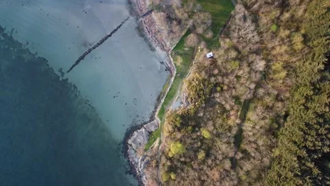 Aerial top-down view of a rocky Norwegian fjord coastline with a secluded hidden Video stock 335198733