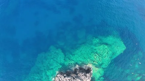Aerial Top Down View of Rocky Coast and Turquoise Sea Greece Stock Footage 336839973