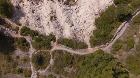 Aerial top down view of rocky coastal terrain and paths in Croatia Stockbeeldmateriaal 337183275