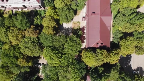 Aerial top down view on roofs of houses in the city on a Sunny summer day Stock Footage 142542123