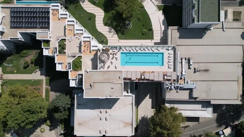 Aerial top-down view of a rooftop swimming pool on a modern hotel building Stock Footage 316838133