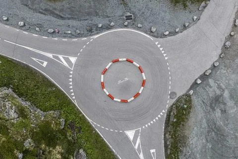 Aerial top-down view of a roundabout, center marked with red and white lines, Stock Photos