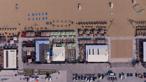 Aerial top down view of a row of summer beach clubs and restaurant pavilion Stock Footage 340041749