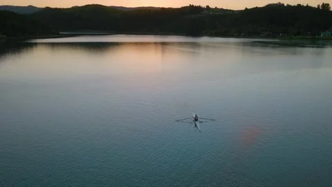 Aerial: top down view of Rower exercising in a calm estuary Stock-Footage 187370427