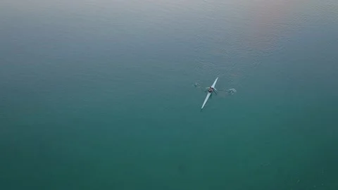 Aerial: top down view of Rower exercising in a calm estuary Video stock 187370482