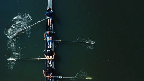 Aerial top down view of a rowing crew training in a lake Stock Footage 331686216