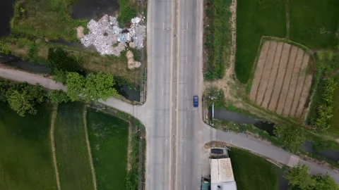 Aerial Top Down View of Rural Intersection and Green Rice Fields 4K 스톡 동영상 334047212