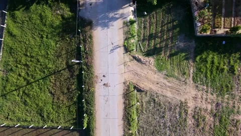 Aerial top-down view of a rural road with a motorbike in Vietnam 스톡 동영상 336610241