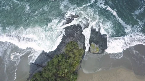 AERIAL Top-down view of sand beach bay seperated with rock formation Stock Footage 119699933