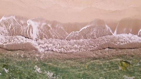 Aerial top down view on a sandy beach with sea surf slow motion nobody Stock Footage 233813159