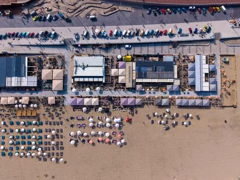 Aerial top-down view of Scheveningen beach clubs, sun umbrellas, a sandy Stock Photos