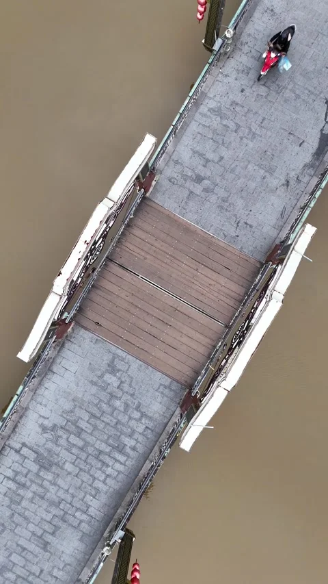 Aerial Top Down View of Scooters Crossing a Bridge in Hoi An, Vietnam Stock Footage 335832215
