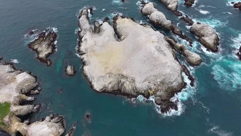 Aerial Top-Down View of Sea Stacks and Rock Formations Off the Coast Stock Footage 337726542
