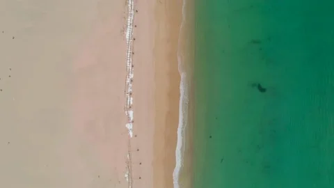 Aerial top down view of seashore with calm transparent sea water and little Stock Footage 151024695