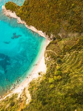 Aerial top down view secluded non commercialized Filikuri rocky beach.Clear.. Stockfoto's