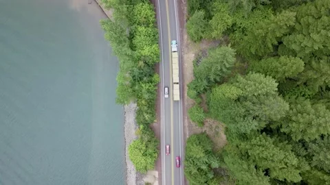 Aerial top down view of semi-truck driving on the highway in a rural area. Stockbeeldmateriaal 167614079