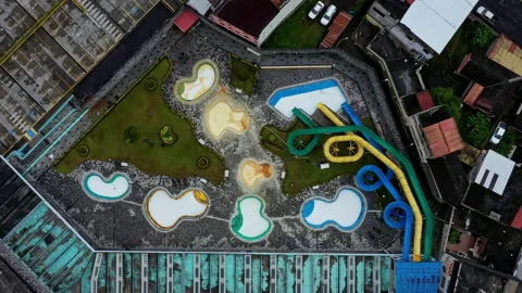 Aerial top down view of several swimming pools and three slides Stock Footage 234967830