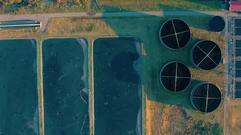Aerial top down view of sewage treatment plant. Industrial water treatment with Stock Footage 279643677