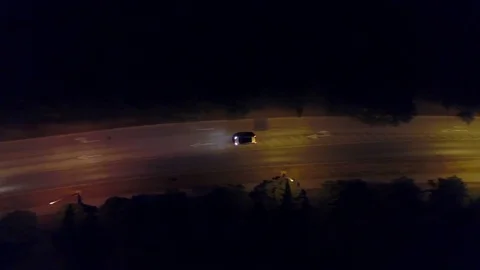 Aerial top down view shot of a rural European car road and roundabout at night Stock Footage 79010014