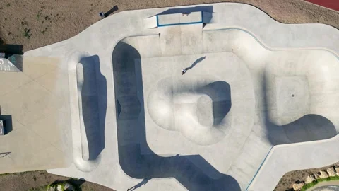 Aerial top down view of skate track with a boy training. Daylight Stockbeeldmateriaal 262332863