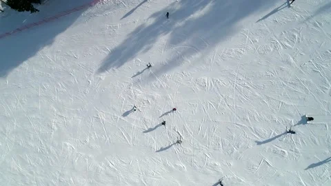 Aerial top down view on a ski slope, people snowboarding and skiing down the Stock Footage 153716919