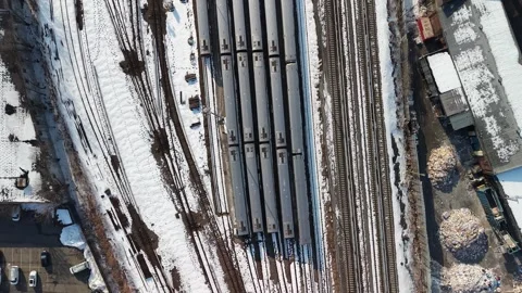 Aerial top down view slowly flying over a railway depot with multiple passenger 動画素材 331086719