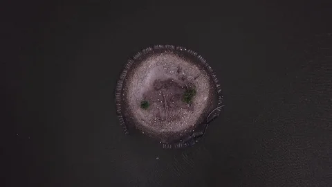 Aerial top down view of a small island on a lake. - 4K Stock Footage 85322254