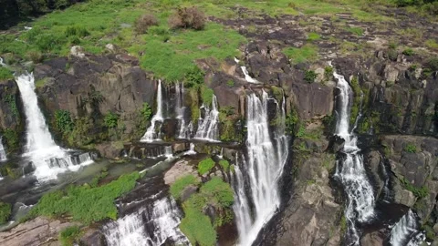Aerial top down view of small waterfall cascades flowing onto the rocky cliff. Stock Footage 153821135