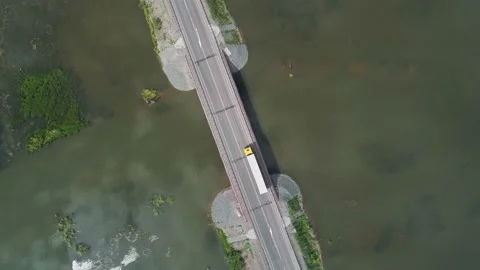 Aerial top down view of small road bridge across the river in rural area. Cars Video stock 196297620