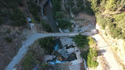 Aerial top down view of a small bridge over a river and small waterfall Stock Footage 343961965