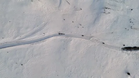 Aerial top down view of snowmobile sliding on a road covered by snow Stock Footage 296550553