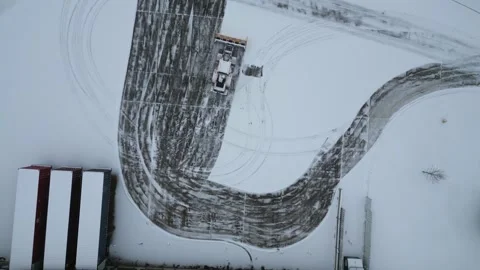 Aerial Top Down View of Snowplow Clearing Industrial Parking Lot Stock-Footage 332385413