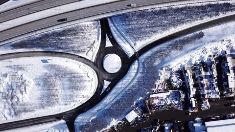 Aerial top down view on snowy highway e18 and houses covered with snow in Norway Stock Footage 86285143