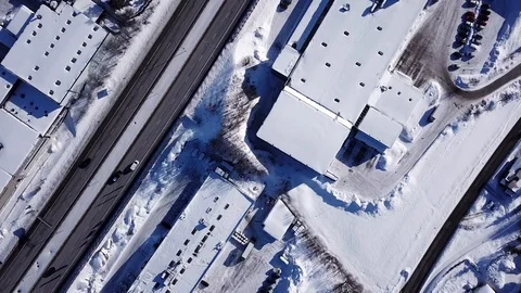 Aerial top down view on snowy highway e18 and houses covered with snow in Norway Stock Footage 86286421