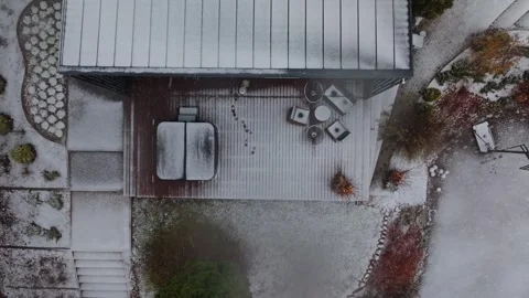 Aerial top down view of snowy deck, hot tub, and basketball hoop Stock Footage 324796804