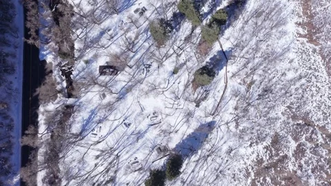 Aerial top down view of snowy park and picnic area in Millcreek Canyon Utah Stock Footage 333881487