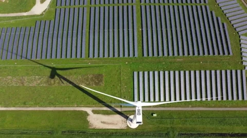 Aerial top down view of  solar park and a wind turbine 4k Stock Footage 163146009
